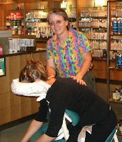 Sandy providing chair massage at an event at Nordstroms
